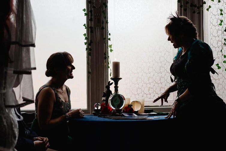 tarot3-41223 Sylvia Sceptre gives a wedding guest a tarot reading.